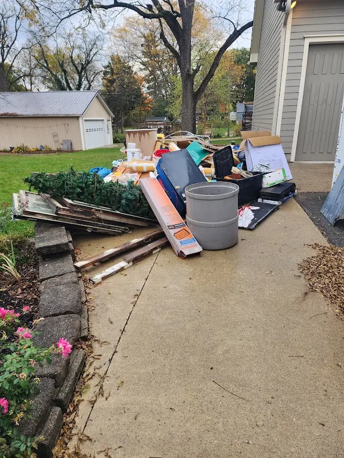 Dumpster being loaded with debris for Residential Dumpster Rental in Stoughton